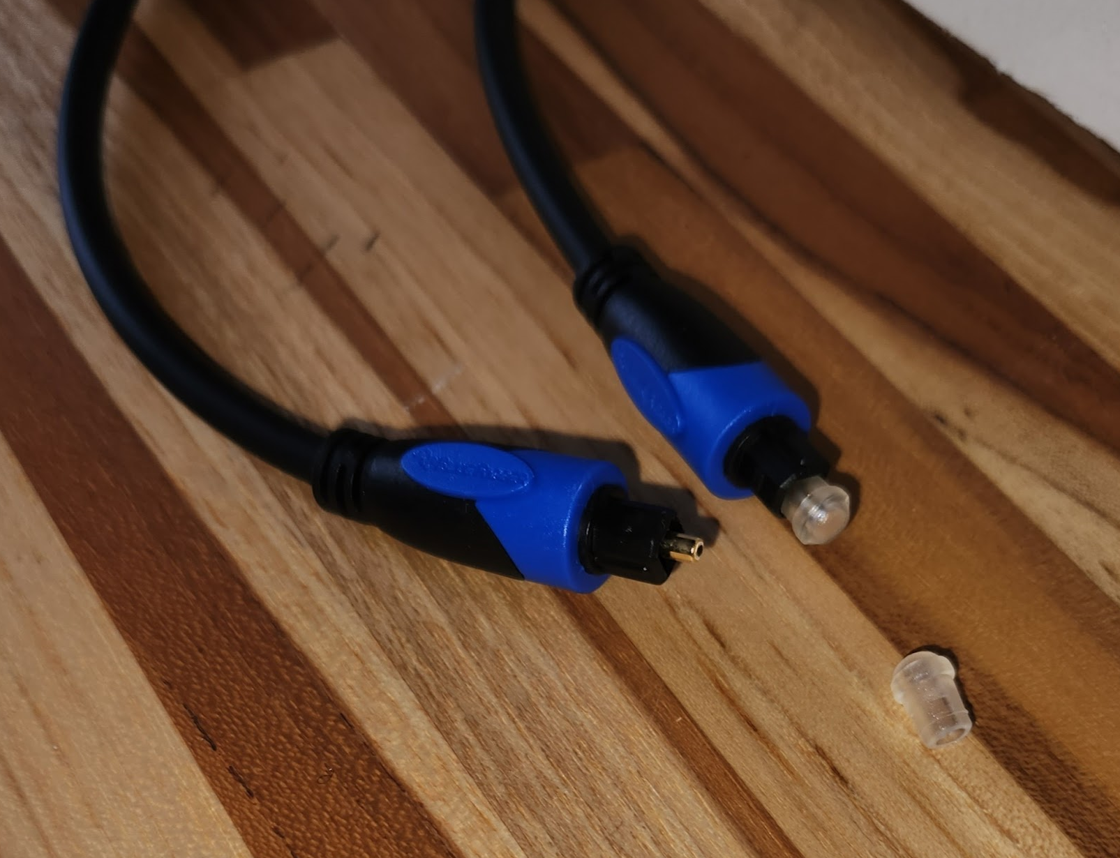 Toslink / SPDIF / ADAT cable<br>One end has a cap on; the other cap is shown in the foreground