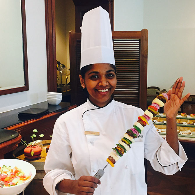 Happy chef offering a sample of her food